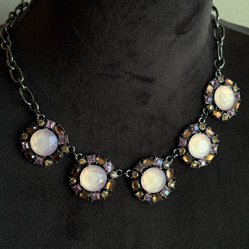 Black link chain choker with 5 large pink flower shaped charms.